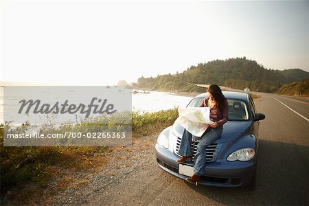 Woman on Side of Highway with Map, Pacific Coast Highway, California, USA