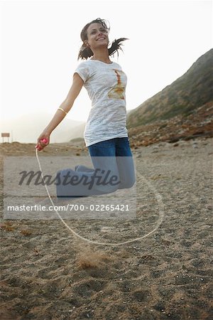 Woman Skipping on Beach