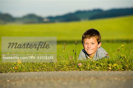 Boy in Grass at Side of Road, Hof bei Salzburg, Salzburg, Austria