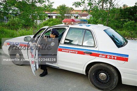 Police Woman Stepping out of Cruiser, Toronto, Ontario, Canada