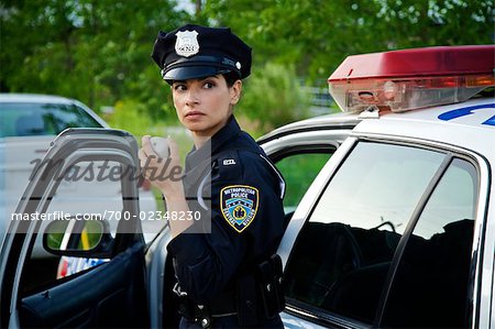 Police Woman with Cruiser at Side of Road, Toronto, Ontario, Canada