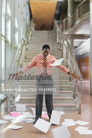 Businessman Throwing Papers Up in the Air