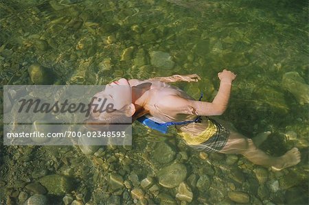 Boy Floating in River