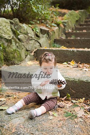 Girl with Pine Cone by Stone Steps
