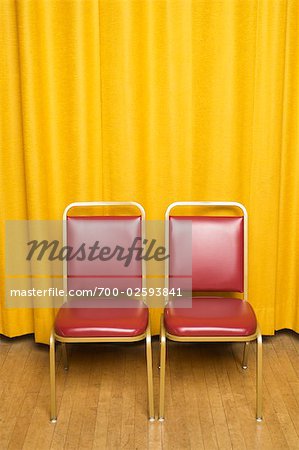 Chairs on Stage with Yellow Curtains
