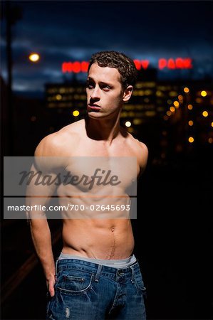 Portrait of Young Man Standing Outdoors at Night, Portland, Oregon, USA