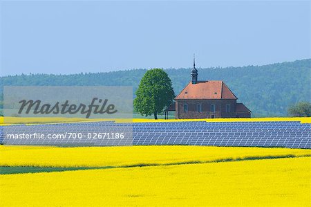 Solar Panels in Canola Field with Church, Bavaria, Germany