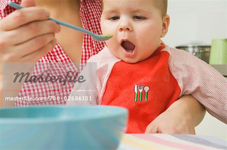 Woman Spoon Feeding Baby