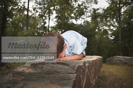 Boy Lying Face Down on Rock