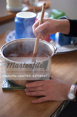 Woman Stirring Melted Chocolate in Pot