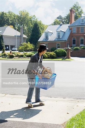 Teenager Taking the Recycling Box to the Curb