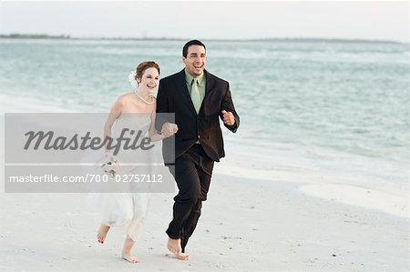 Newlyweds Running on Beach