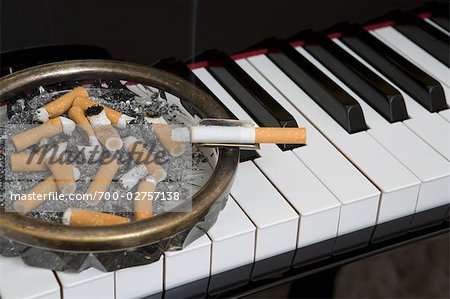 Ashtray and Cigarette on Piano