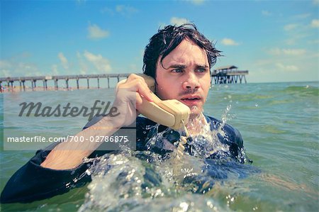 Businessman in the Ocean Talking on Telephone