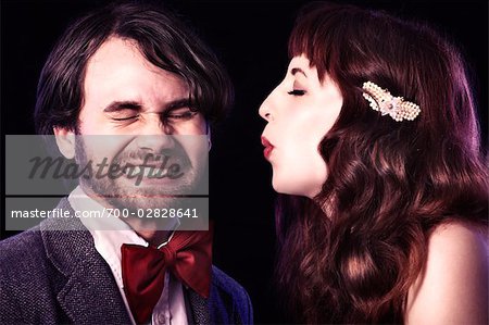 Close-up of Woman Blowing in Man's Face