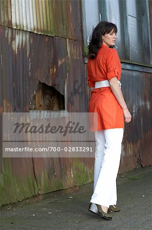 Rear View of Woman Outside Run Down Building