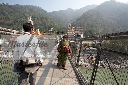 People Crossing Lakshman Jhula Bridge over Ganges River, Rishikesh, Uttarakhand, India