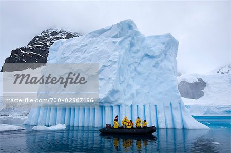 People in Zodiac Boat by Iceberg, Antarctica