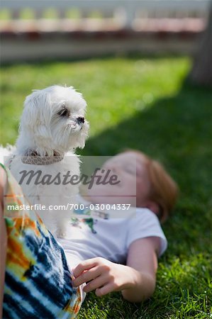 Girl Lying on Grass with Dog