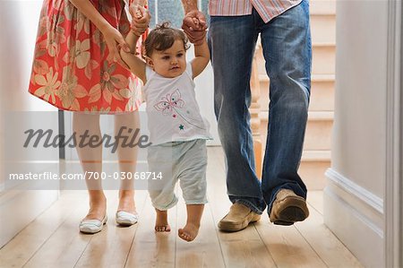 parents walking with baby