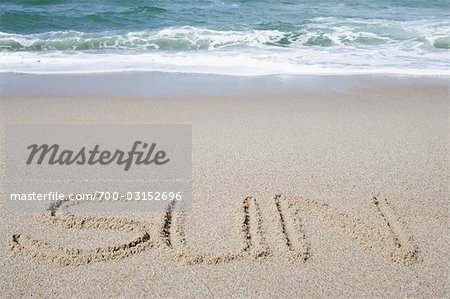 Sun Written in Sand at Beach