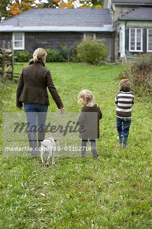 Mother and Children Walking towards House