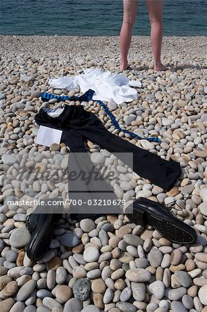 woman taking off clothes on beach, Stock Photo, Picture And Rights