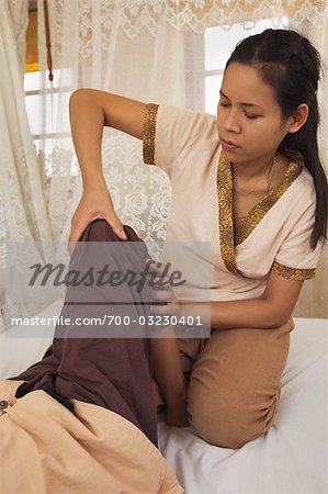 Woman performing Thai Massage, Bangkok, Thailand