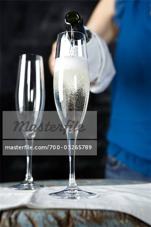 Woman Pouring a Glass of Champagne