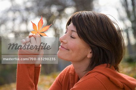 Woman Holding Autumn Leaf