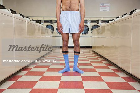 Man taking off underpants Stock Photos - Page 1 : Masterfile