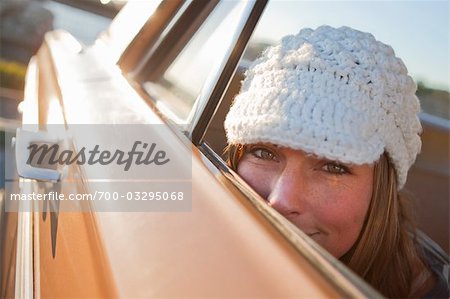 Woman Peeking Out the Window of a Vintage Car, Santa Cruz, California, USA