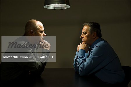 Two Businessman in Interrogation Room