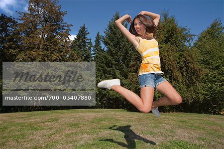 Teenage Girl Jumping in Air