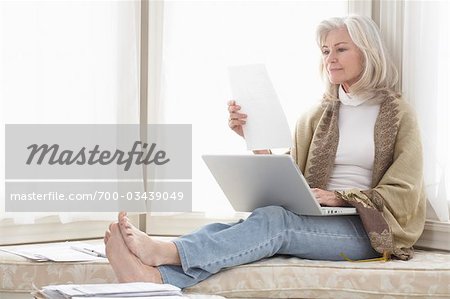 Woman at Home Using Laptop Computer