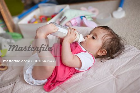 Toddler Girl Drinking Milk From A Bottle Stock Photo, Picture and Royalty  Free Image. Image 102654580.