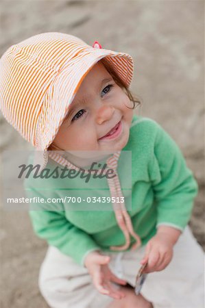 Close-up of Baby Girl Sitting on Beach, Near Seaside, Oregon, USA