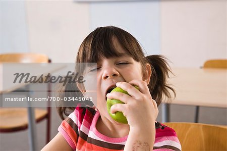 Girl in Class Eating an Apple