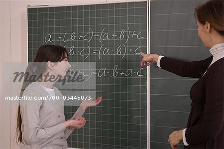 Teacher Helping Student With Math Equation