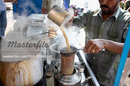 Chai Wallah Pouring Masala Chai, India