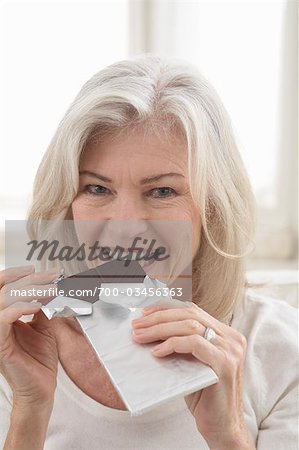 Mature Woman Eating Chocolate