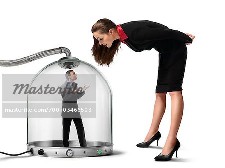 Businesswoman looking at Businessman inside of Pressurized Glass Dome