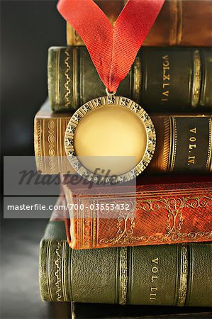 Close-up of Golden Medal with Leather Bound Books