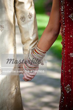 Close-up of Bride and Groom Holding Hands