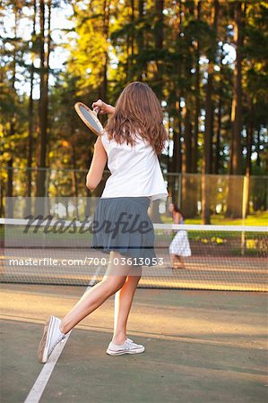Two Young Women Playing Tennis