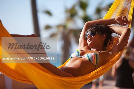 Woman Lying in Hammock at Sunrise, Near Cabo Pulmo, Baja California Sur, Mexico