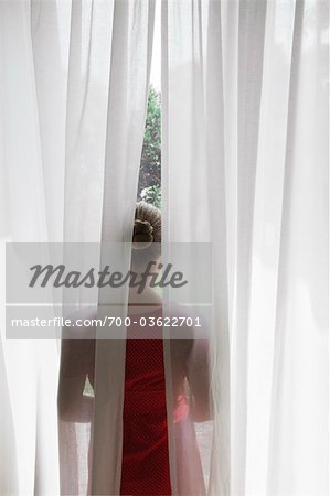 Rear View of Woman Looking out Window