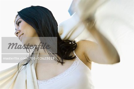 Woman Putting Blanket Over Her Shoulders