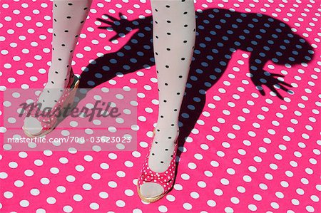 Woman Wearing Polka Dot Tights and Shoes Standing on Polka Dot Surface