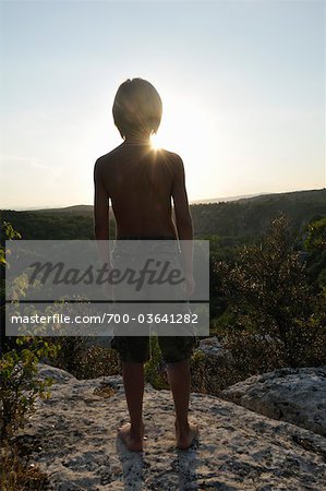 Boy Standing on Cliff